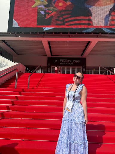 A woman stands on the red carpet at the Cannes Lions Festival.